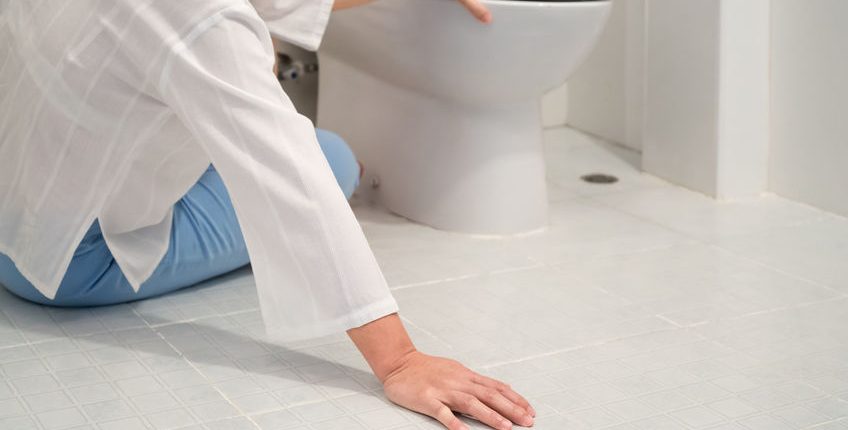woman seated by toilet